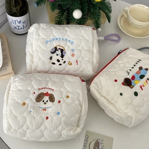 Quilted white puppy makeup bag with heart stitching and cute dog embroidery pattern