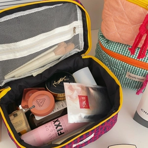 Quilted checkerboard cosmetic bag with large capacity main compartment and mesh pocket