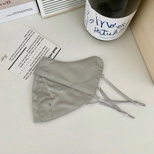 Detail of light gray mulberry silk sun protection mask with adjustable ear loops and soft texture