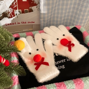 Detail of white plush snowman gloves with festive red bow and reindeer elements
