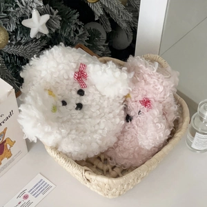 Detail of plush poodle hot water bottle covers in white and pink with red bows