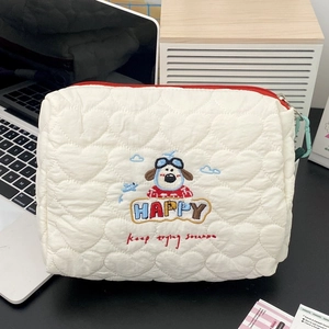 Close-up of heart quilted makeup bag with cute cartoon dog pilot embroidery and red zipper