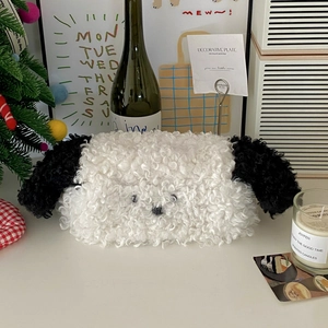 Close-up of plush puppy tissue box made of soft white curly fleece with cute ear detail