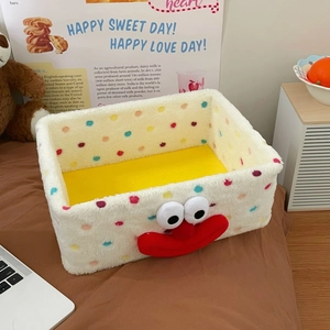Detailed view of plush storage basket with colorful polka dots and cute cartoon face