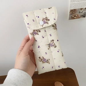 Close-up of quilted cream eyeglass pouch with cute bear floral pattern and button