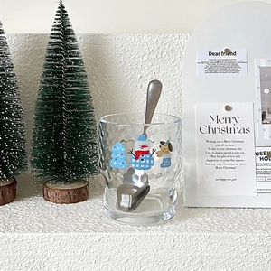 Detailed view of hammered glass cup with cute snowman and Christmas cartoon illustration