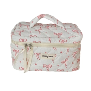 Floral bow quilted makeup bag with top handle and double zipper in white and pink