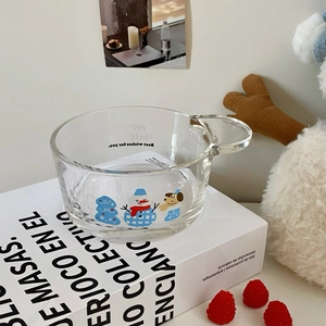 Detail of Christmas snowman glass bowl with handle and festive winter illustrations