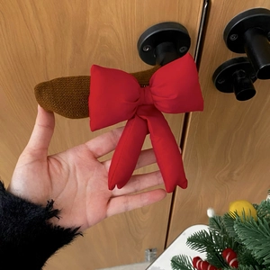 Close-up of a festive Christmas reindeer ear headband with a large red satin bow knot