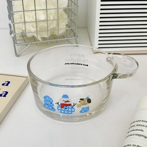 Detail view of transparent Christmas snowman glass bowl with handle and holiday illustrations