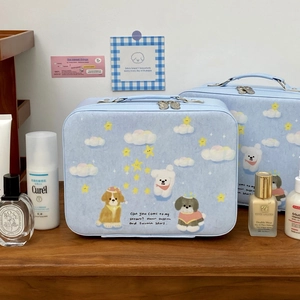 Light blue cosmetic case with cartoon dogs and double zipper on wooden surface