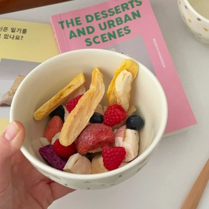 Detail of colorful stars ceramic bowl filled with assorted freeze-dried fruits and berries