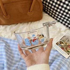 Detail of a Christmas glass bowl with snowman and dog prints featuring a round handle