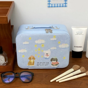 Blue dog pattern makeup case with vanity brushes and skincare on a wooden table