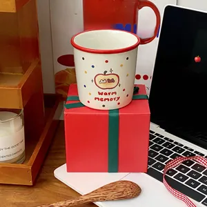 Detailed view of apple ceramic mug with polka dots next to a festive red gift box
