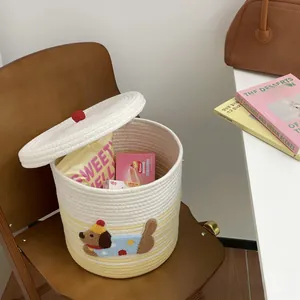 Close-up of woven cotton storage basket featuring a cute puppy patch and red knob lid