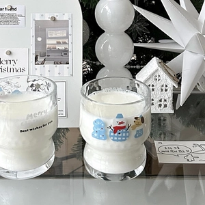 Detailed view of Christmas glass mugs with cute snowman illustration and festive text