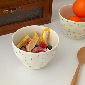 Detailed view of cream ceramic bowl with stars and flowers for dessert and cereal