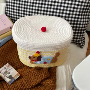 Detailed shot of woven cotton rope storage basket with cute puppy embroidery and lid