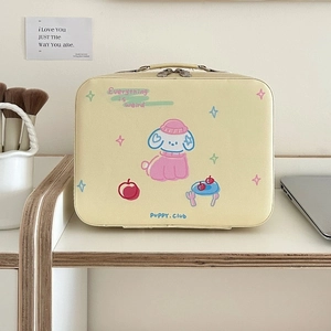 Close-up of a cream PU leather makeup case with cute puppy print and sturdy top handle
