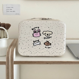 Detail of a white spotted makeup box with cartoon animal prints and a sturdy handle