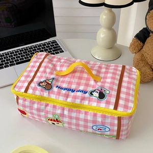 Detail of pink plaid storage bag with yellow handle and cute cartoon dog print