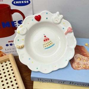 Detail of cute relief ceramic plate with 3D rabbit and heart patterns on wavy edges