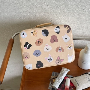 Detail of cartoon dog pattern on beige PU leather vanity case with portable handle