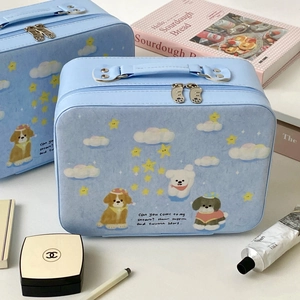 Detail of light blue vanity case featuring cute dog prints and dual metal zippers