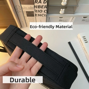 Close-up of a durable black canvas storage bag featuring a wide portable hand strap