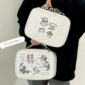 Detailed view of two white waterproof cosmetic bags with cute cartoon and dog prints