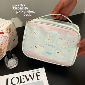 Detail of cute puppy print portable makeup bag with top handle in pink and blue colors
