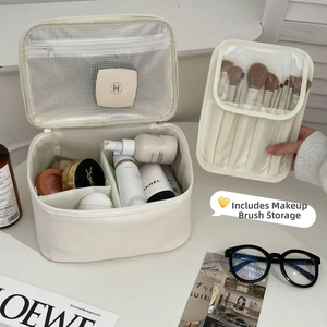 Detail of white leather makeup bag with detachable brush holder and spacious interior