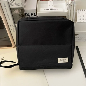 Detail of black portable makeup bag with Campus MOKA label and durable webbing handle