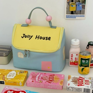 Detail of house-shaped insulated lunch bag with heart zippers and dual handles