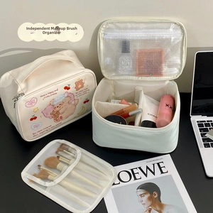 Detailed view of cream cosmetic bag set with bear prints and internal compartments