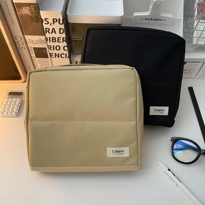 Vertical canvas makeup bags in black and khaki with brand label and textured finish