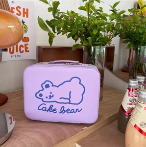 Close-up of purple PU leather vanity case with a cute cartoon bear and handle