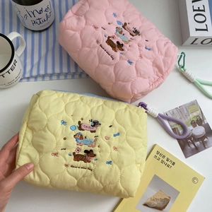 Quilted makeup bag with cute dog embroidery and hand strap for travel skincare storage