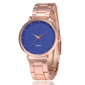 Detail view of rose gold quartz watch with a minimalist blue dial and metal link bracelet