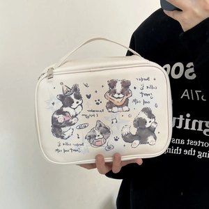Detail of handheld white leather makeup bag featuring cartoon border collie illustrations