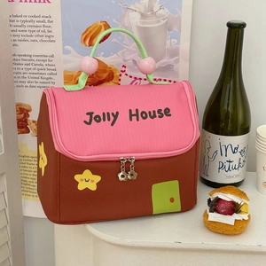 Detail of pink lunch bag showing dual zippers and cute star decoration with handle