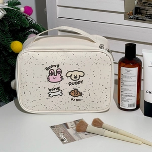 Close-up of a white waterproof makeup bag with cartoon rabbit and puppy illustrations