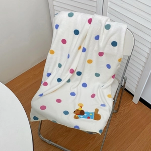 Close-up of soft dalmatian spot bath towel with cute embroidered puppy and colorful dots