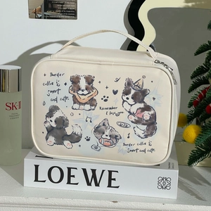 Detail of cream makeup bag with border collie print next to skincare products