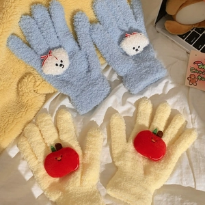 Close-up of coral fleece gloves with cute cartoon dog and apple patterns on soft fabric