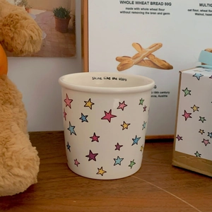 Ceramic cat mug with colorful stars and Shine like the stars text inside the rim
