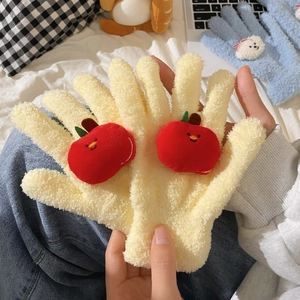 Close-up of soft creamy yellow coral fleece gloves with a cute red 3D apple detail