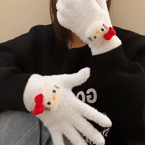 Detailed close-up of fluffy white coral fleece gloves featuring Hello Kitty 3D characters