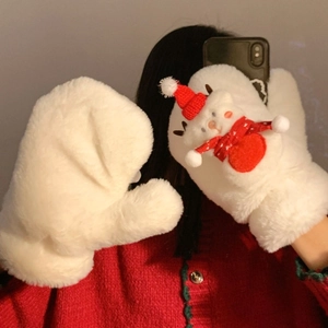Detail of plush white mittens with a cute 3D Christmas bear decor for winter warmth
